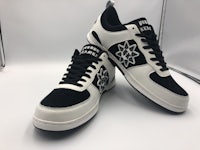 a pair of black and white sneakers with a star on them